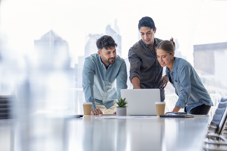 Business team working on a laptop computer.